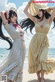 A couple of women standing next to each other on a beach.