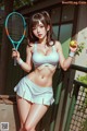 A woman in a white bikini holding a tennis racket and ball.